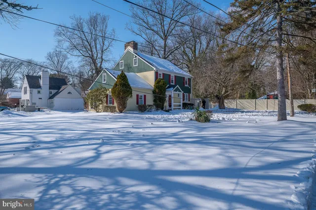 a living room with wooden floor and a fireplace