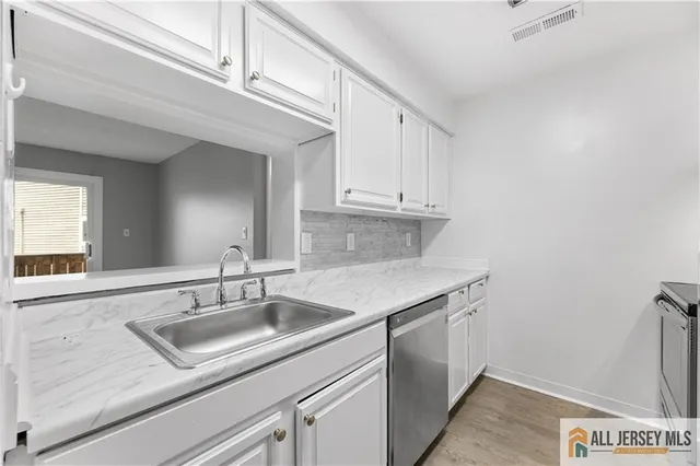 a kitchen with a sink and cabinets