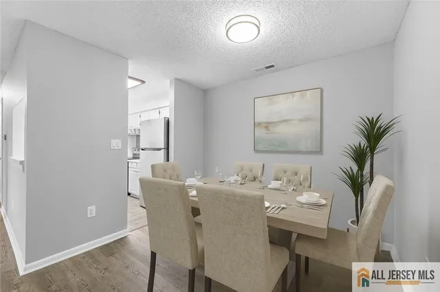a view of a dining room with furniture and window