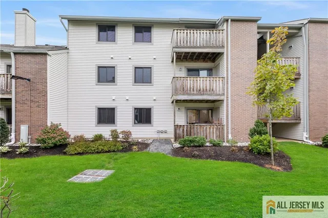 a view of a white house with a yard