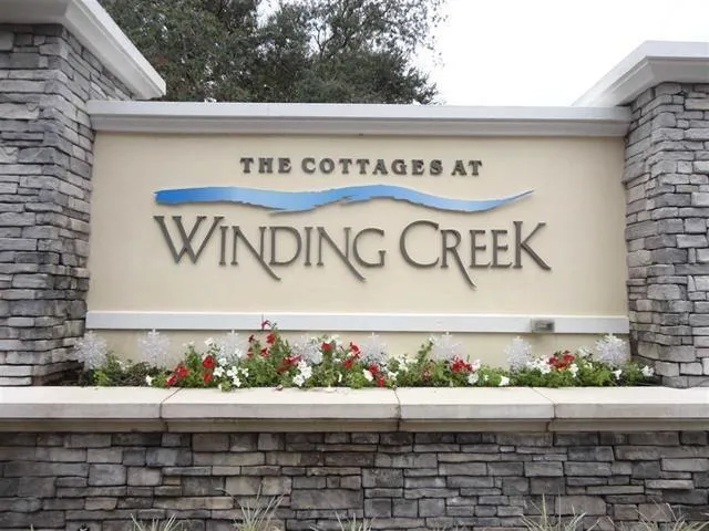 a street sign on a brick wall