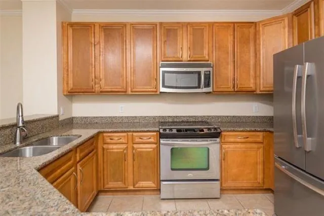 a kitchen with granite countertop cabinets stainless steel appliances and a sink