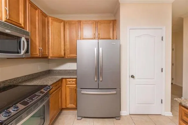 a kitchen with wooden cabinets and a stove top oven