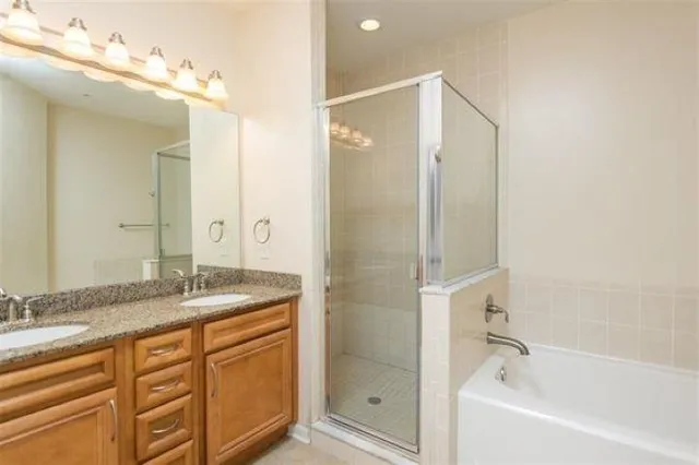 a bathroom with a granite countertop sink mirror and shower