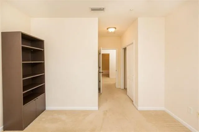 a view of a hallway with wooden shelves