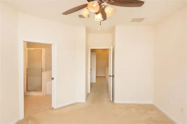 a view of a hallway with a chandelier fan