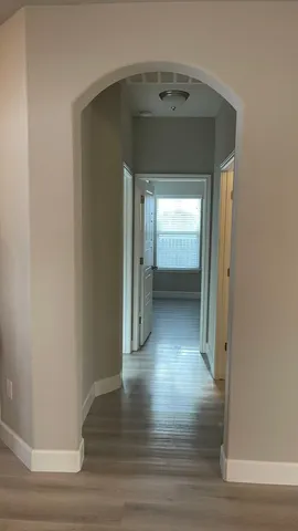 a view of a hallway view with wooden floor and staircase