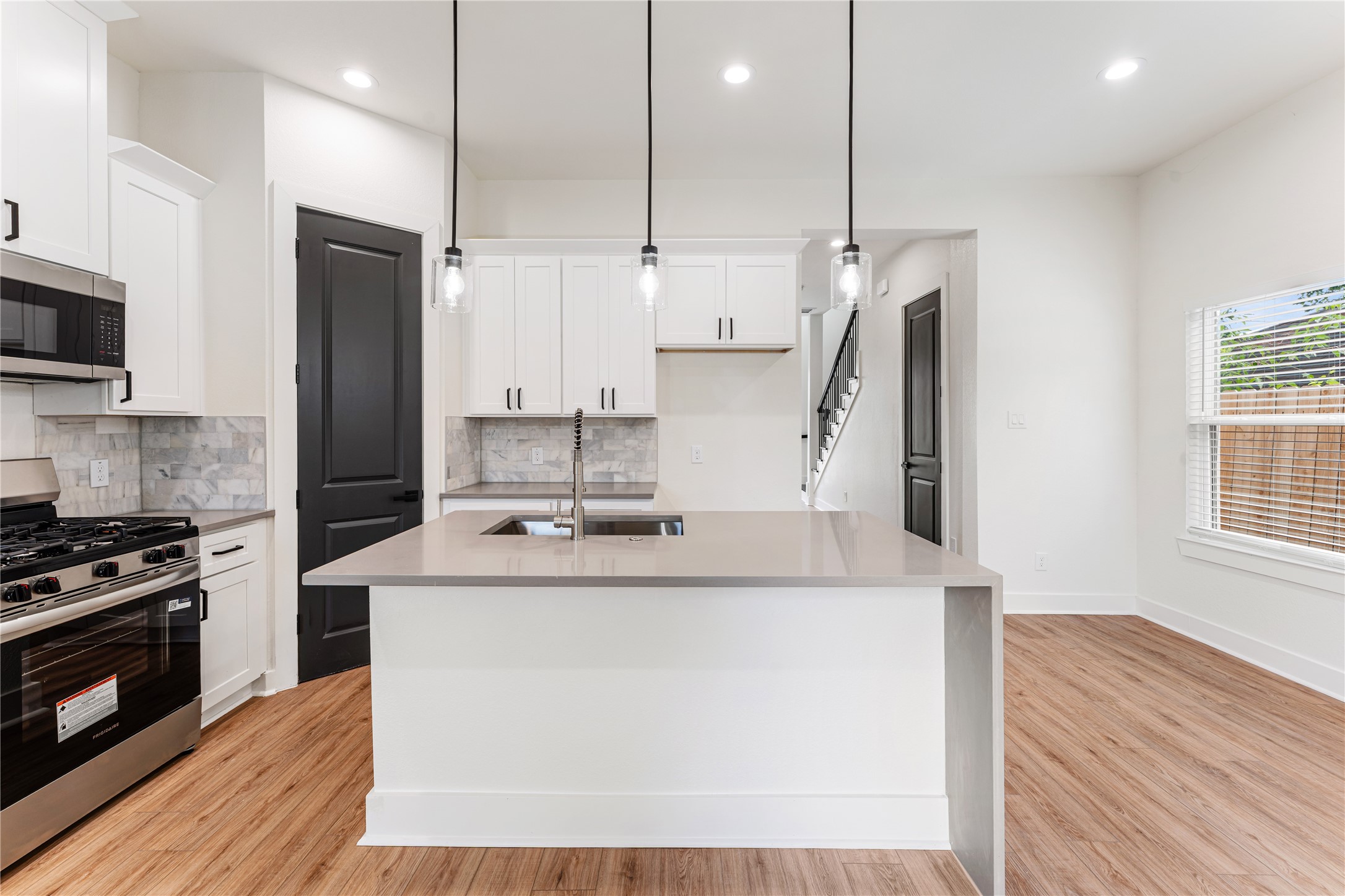 3620 Mt Pleasant Street, Unit A Houston, TX 77021 - Photo 6 of 23 a kitchen with kitchen island stainless steel appliances a sink stove and refrigerator