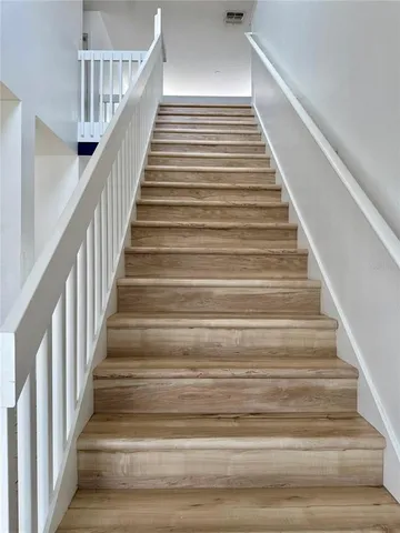 a view of hallway with wooden floor