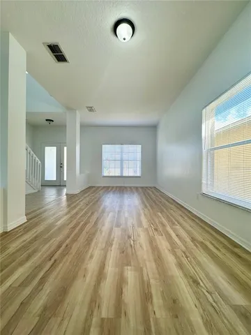 wooden floor in an empty room with a window