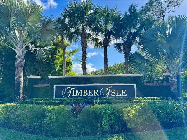 a sign that is sitting in front of flowers