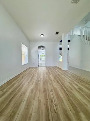 a view of empty room with wooden floor