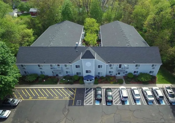 an aerial view of multiple houses with a yard