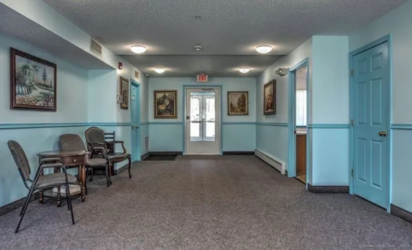 a view of a livingroom with furniture and a window