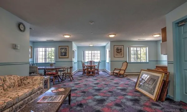 a living room with furniture window and wooden floor