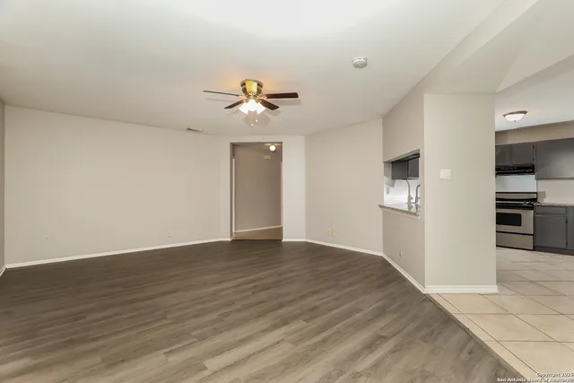 a view of an empty room with a kitchen