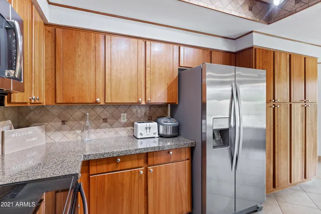 a kitchen with stainless steel appliances granite countertop a sink and a window
