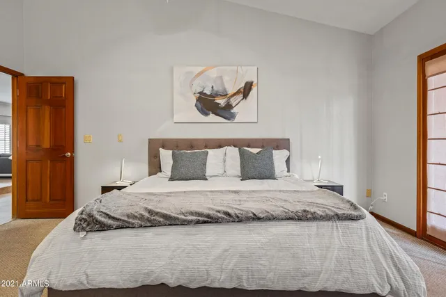 a bedroom with a bed and a flat screen tv