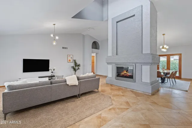 a living room with furniture and a fireplace or television