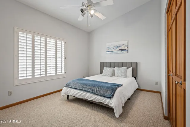 a bedroom with a bed and a window