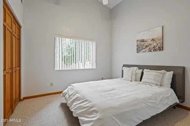 a bedroom with a bed and a window