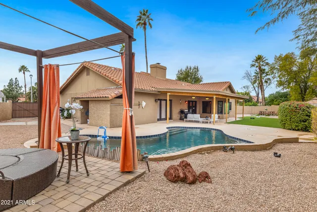 a balcony with table and chairs