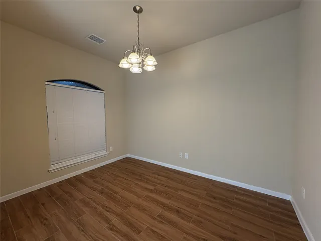 a large kitchen with stainless steel appliances granite countertop a sink and cabinets