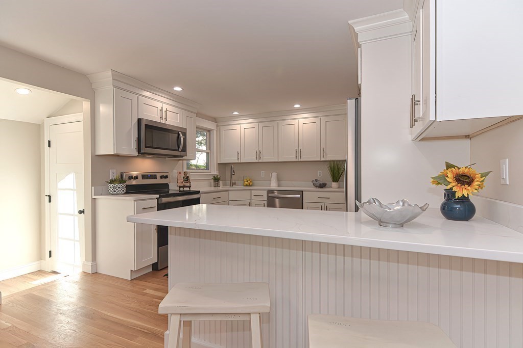 1 Duggan Road Acton, MA 01720 - Photo 8 of 25 a kitchen with stainless steel appliances granite countertop a sink a stove and a refrigerator