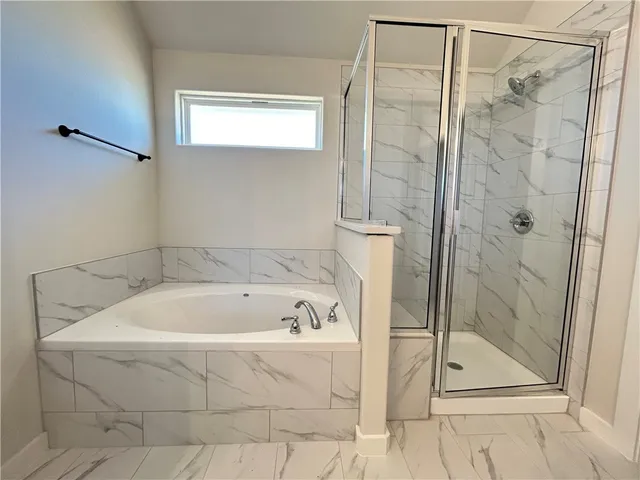 a bathroom with a bath tub and shower