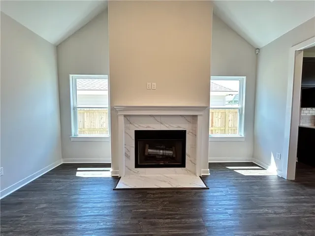 a living room with a fireplace and wooden floor