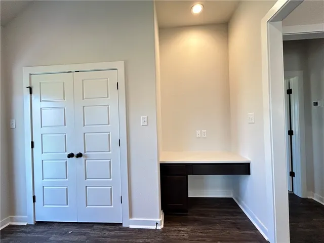 a view of room with wooden floor