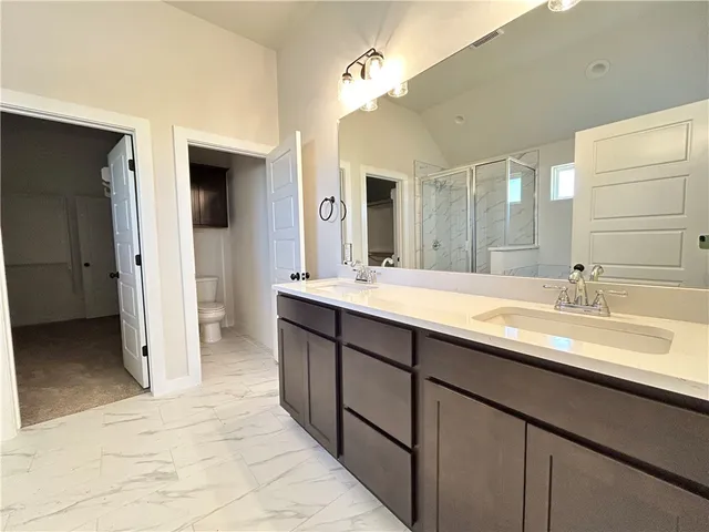 a bathroom with a double vanity sink and a mirror