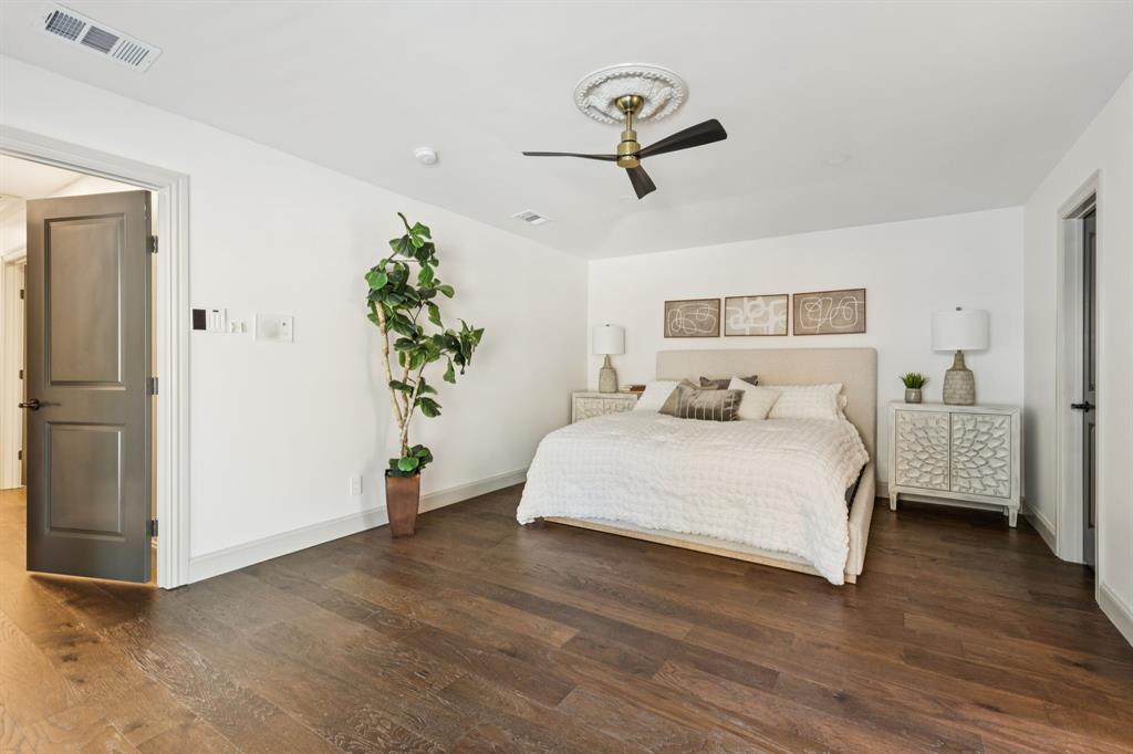 11023 Marsh Lane Dallas, TX 75229 - Photo 15 of 40 a bedroom with a bed and a potted plant