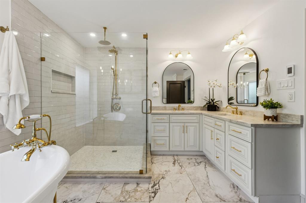 11023 Marsh Lane Dallas, TX 75229 - Photo 18 of 40 a spacious bathroom with a double vanity sink mirror and bathtub