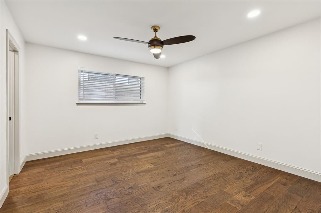 11023 Marsh Lane Dallas, TX 75229 - Photo 19 of 40 an empty room with a ceiling fan and window