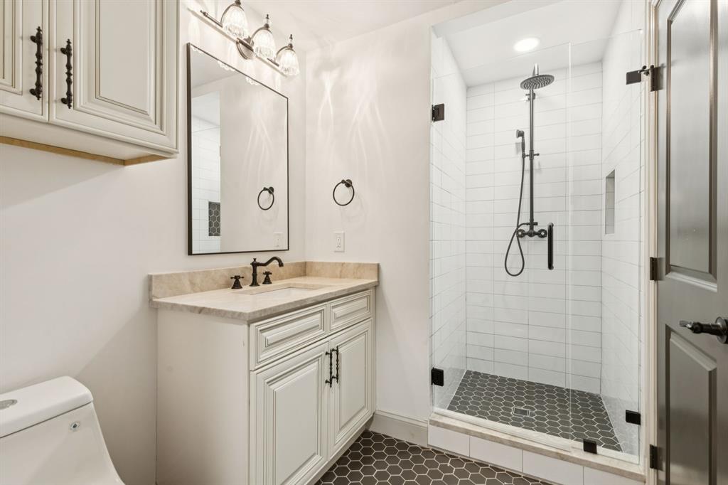 11023 Marsh Lane Dallas, TX 75229 - Photo 24 of 40 a bathroom with a shower sink and mirror