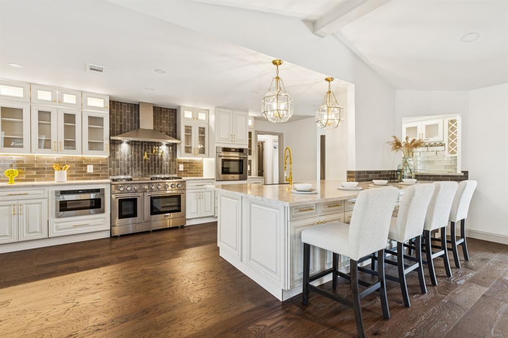 11023 Marsh Lane Dallas, TX 75229 - Photo 3 of 40 a kitchen with stainless steel appliances a white table and chairs