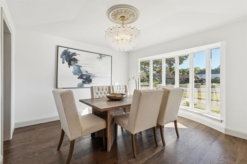 11023 Marsh Lane Dallas, TX 75229 - Photo 8 of 40 a view of a dining room with furniture a chandelier and wooden floor