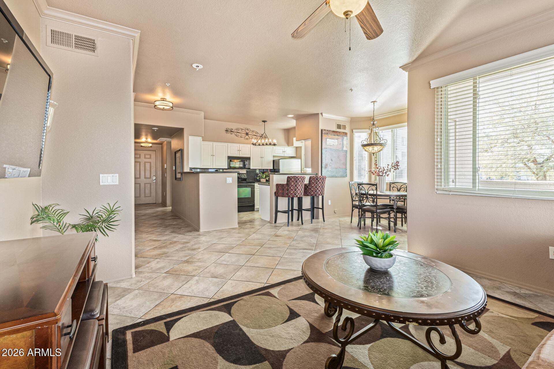425 West Rio Salado Parkway, Unit 101 Tempe, AZ 85281 - Photo 6 of 33 a dining room with furniture a chandelier and wooden floor