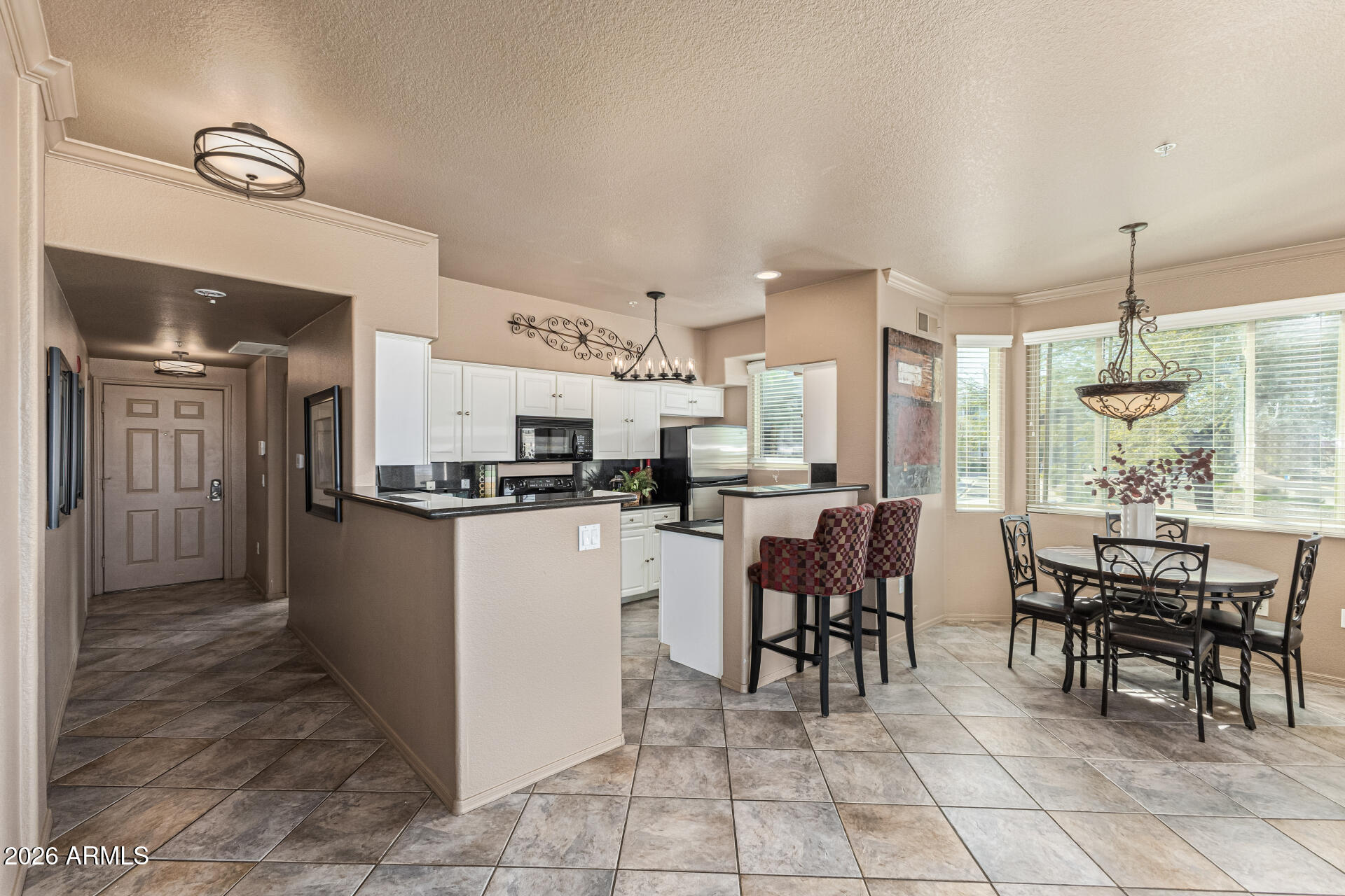 425 West Rio Salado Parkway, Unit 101 Tempe, AZ 85281 - Photo 9 of 33 a kitchen with a dining table chairs and white appliances