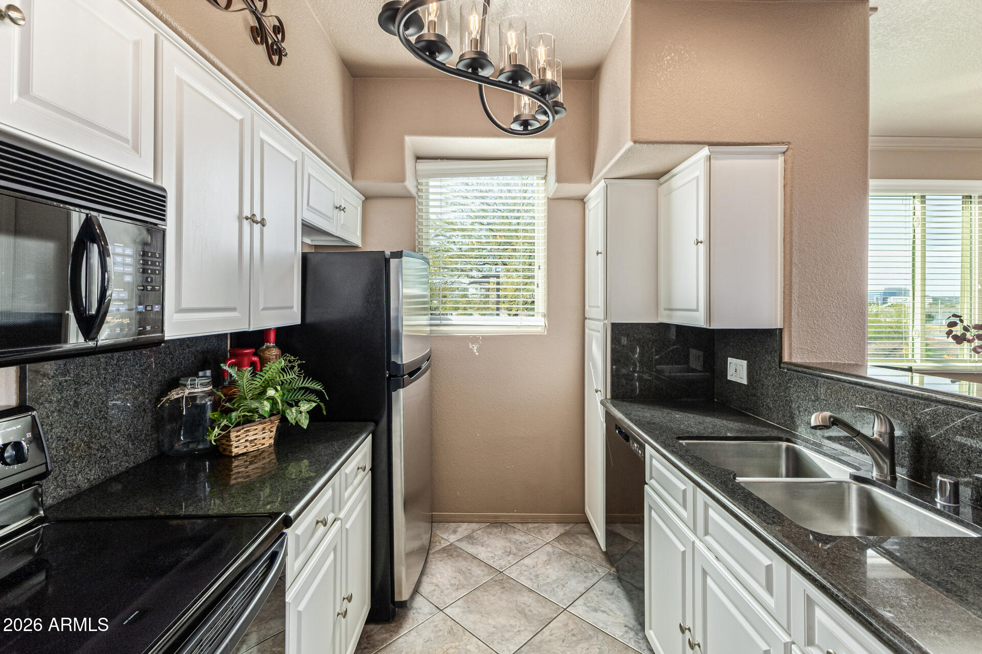 425 West Rio Salado Parkway, Unit 101 Tempe, AZ 85281 - Photo 10 of 33 a kitchen with stainless steel appliances granite countertop a sink a stove and a refrigerator