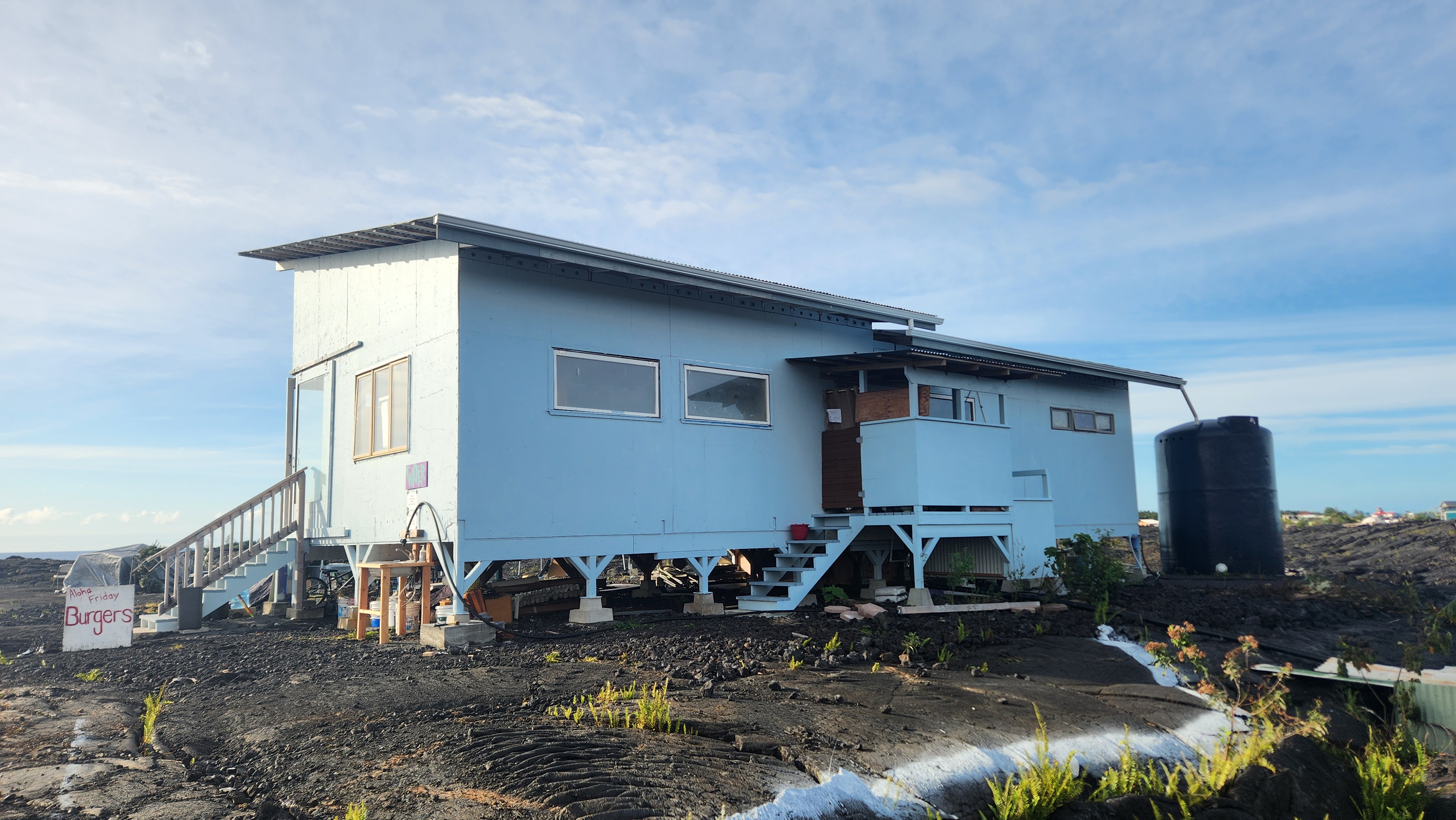 12-4901 Kaimu-Chain Of Craters Road Pahoa, HI 96778 - Photo 8 of 15 a backyard of a house with barbeque oven and outdoor seating