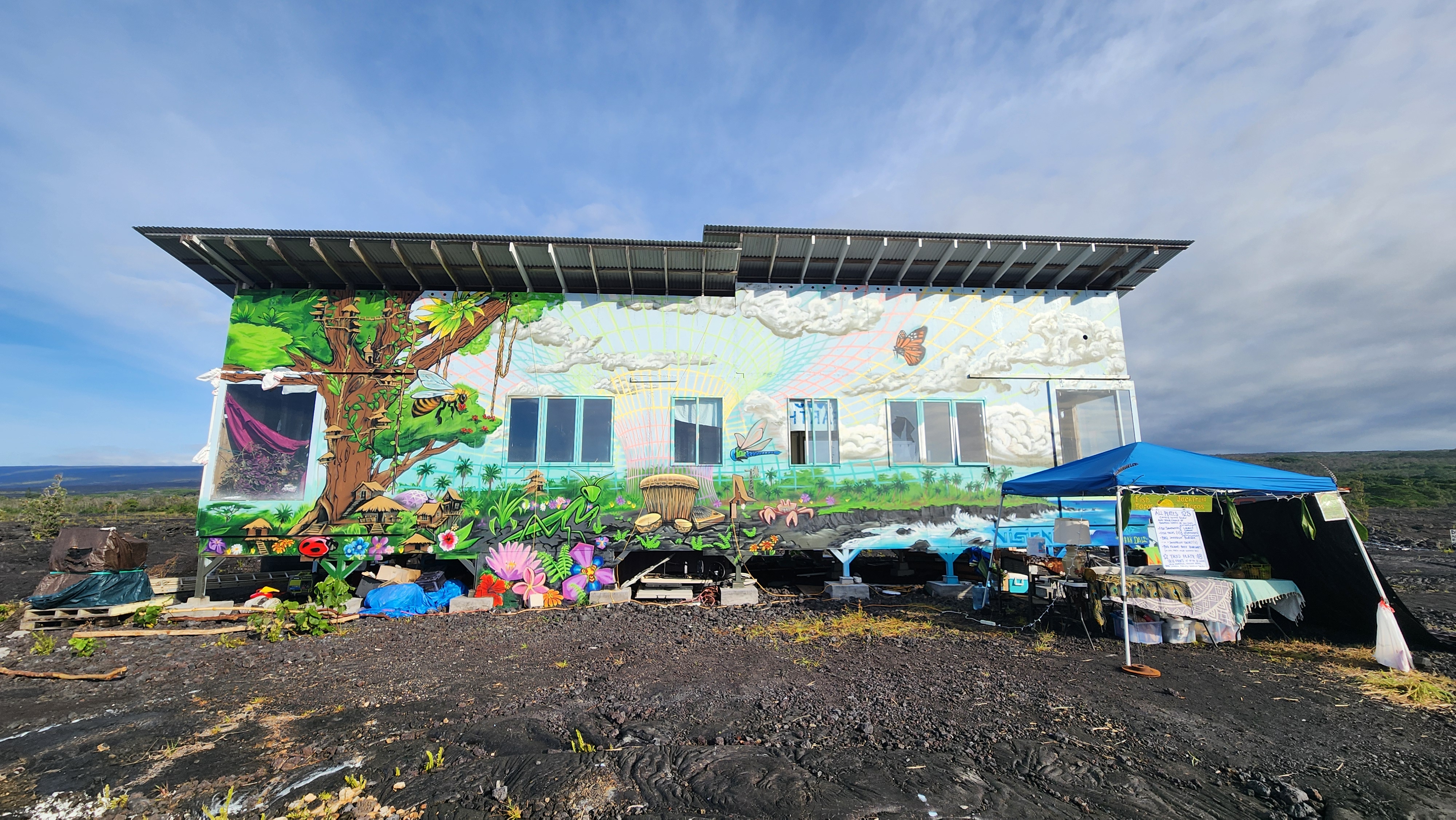 12-4901 Kaimu-Chain Of Craters Road Pahoa, HI 96778 - Photo 9 of 15 a view of a chairs and an umbrella in front of a house