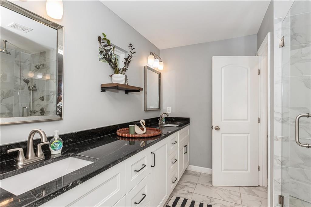 1184 Metropolitan Parkway Southwest Atlanta, GA 30310 - Photo 16 of 26 a bathroom with a sink and a mirror