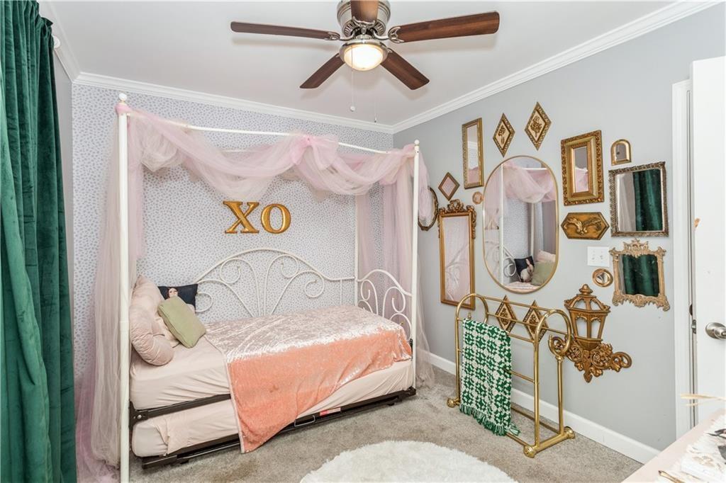 1184 Metropolitan Parkway Southwest Atlanta, GA 30310 - Photo 23 of 26 a bedroom with a bed and painting on the wall