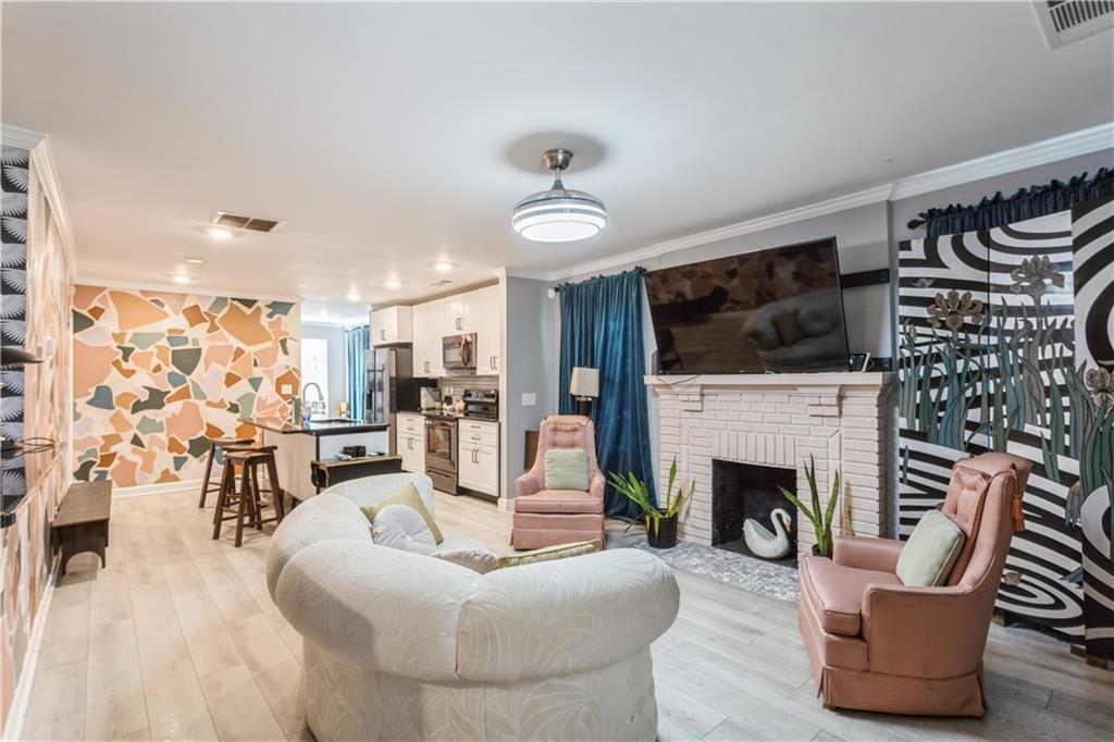 1184 Metropolitan Parkway Southwest Atlanta, GA 30310 - Photo 3 of 26 a living room with furniture a fireplace and a flat screen tv