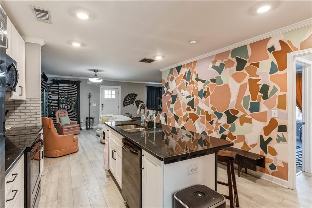 1184 Metropolitan Parkway Southwest Atlanta, GA 30310 - Photo 6 of 26 a kitchen with stainless steel appliances granite countertop a sink and cabinets