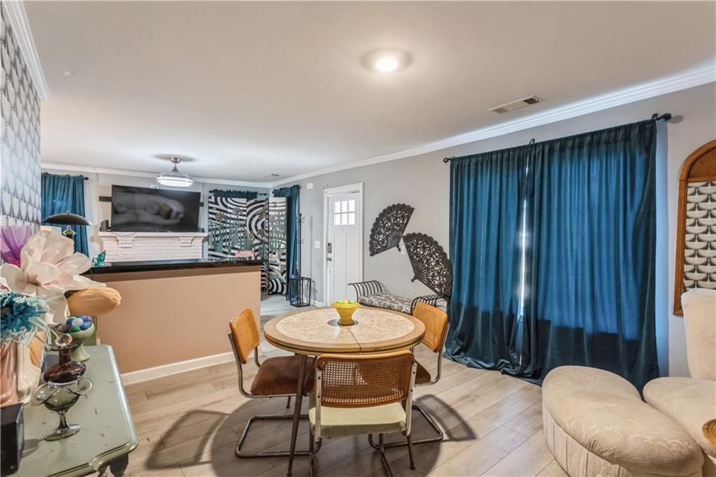 1184 Metropolitan Parkway Southwest Atlanta, GA 30310 - Photo 8 of 26 a view of a dining room with furniture and wooden floor