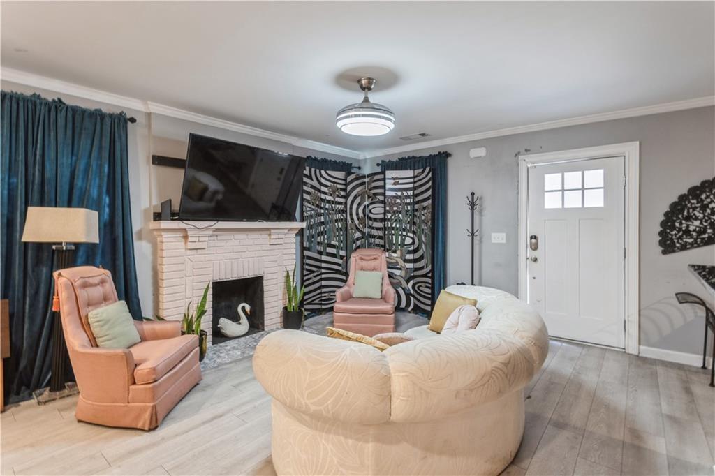 1184 Metropolitan Parkway Southwest Atlanta, GA 30310 - Photo 9 of 26 a living room with furniture a fireplace and a flat screen tv