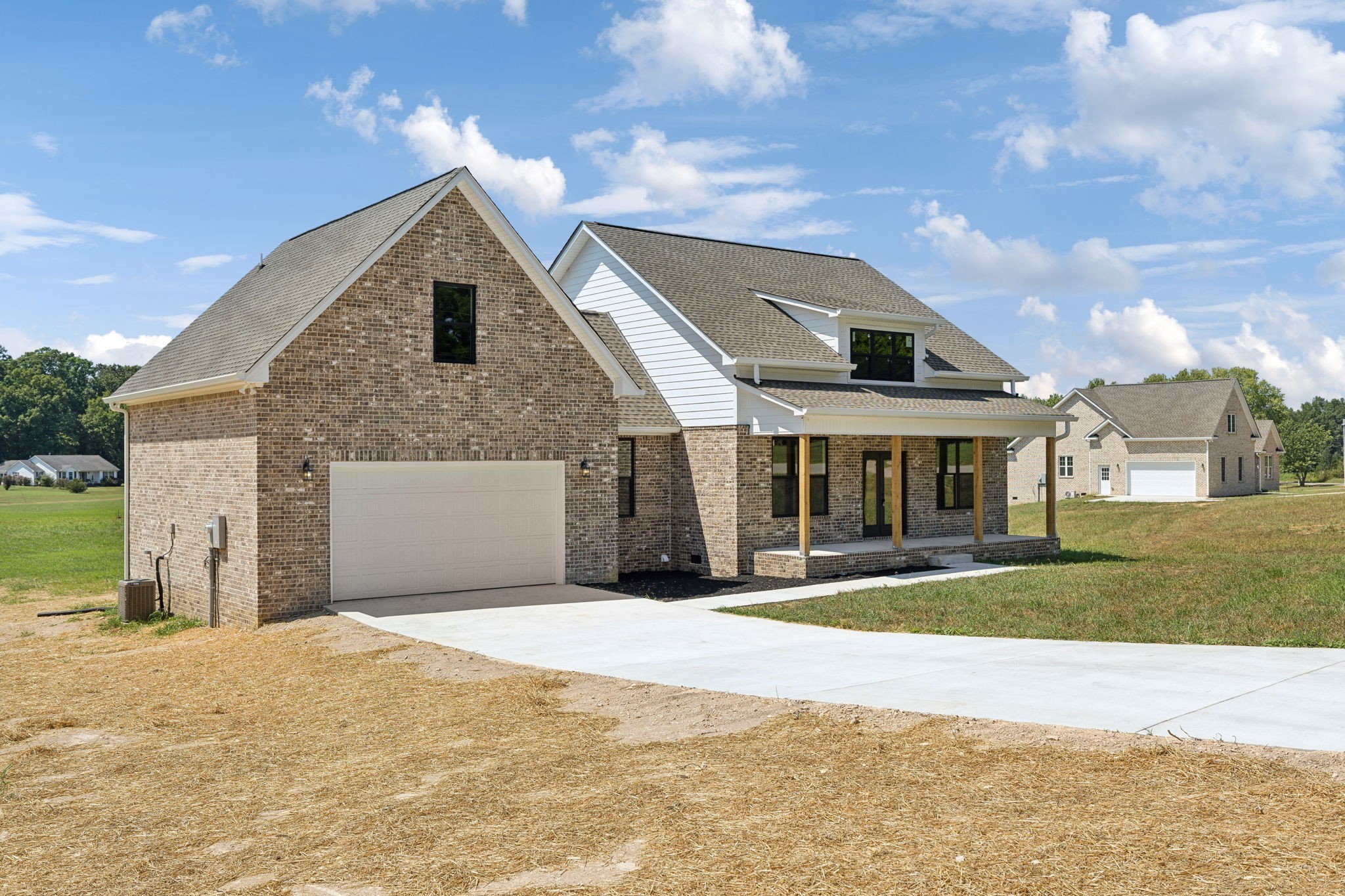 47 Long Branch Road Lawrenceburg, TN 38464 - Photo 5 of 49 a front view of a house with a yard and garage